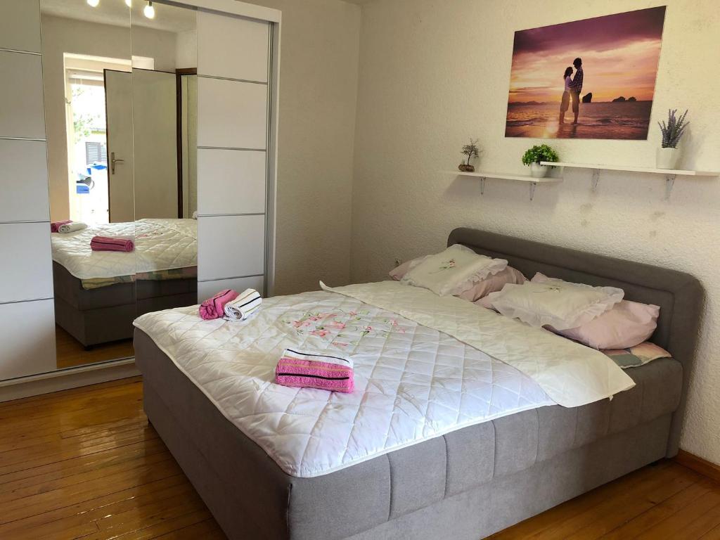 a bedroom with a large bed and a mirror at Old city core in Senj