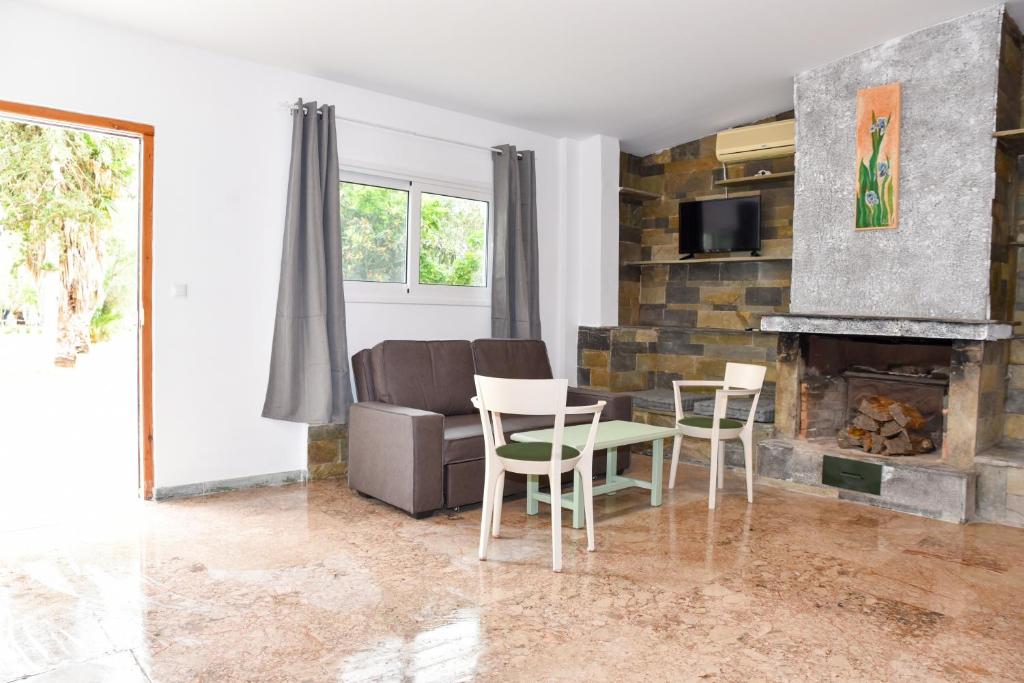 a living room with a couch and a fireplace at Barreira Beachfront Room 1 in Verga Kalamata