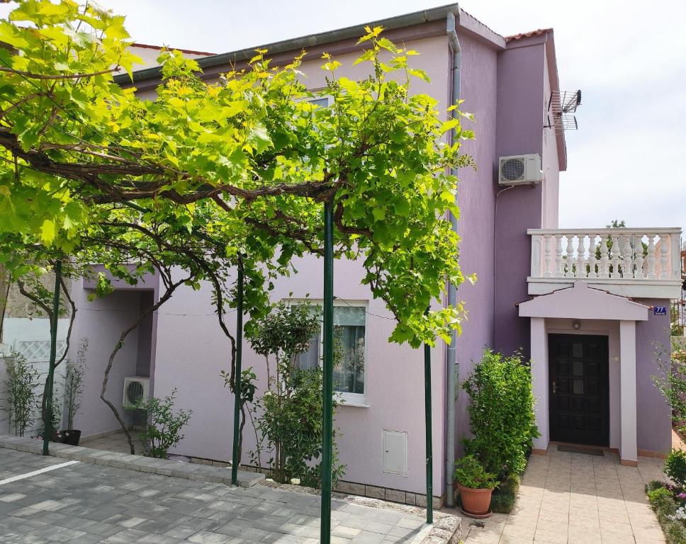 a purple house with trees in front of it at Apartments Tessa 77 in Medulin
