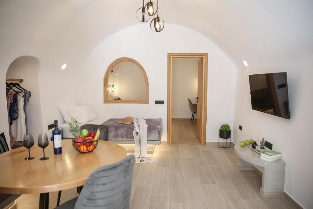 a living room with a table and a couch at Luxury Canava in Emporio