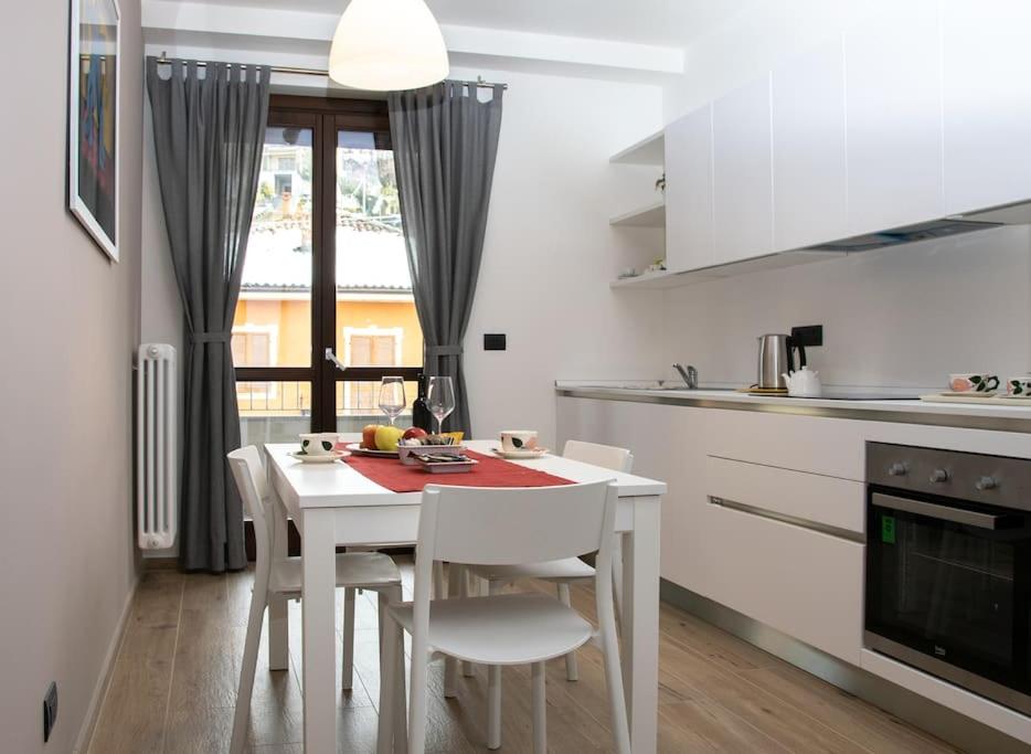 a kitchen with a white table and chairs in a kitchen at Casa Valentin in Monforte dʼAlba