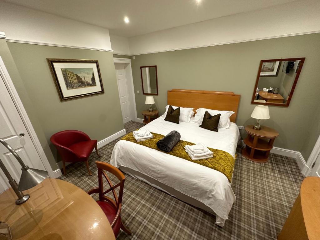 a hotel room with a bed and a table at Birches Brow Boutique Guest Rooms in Aughton