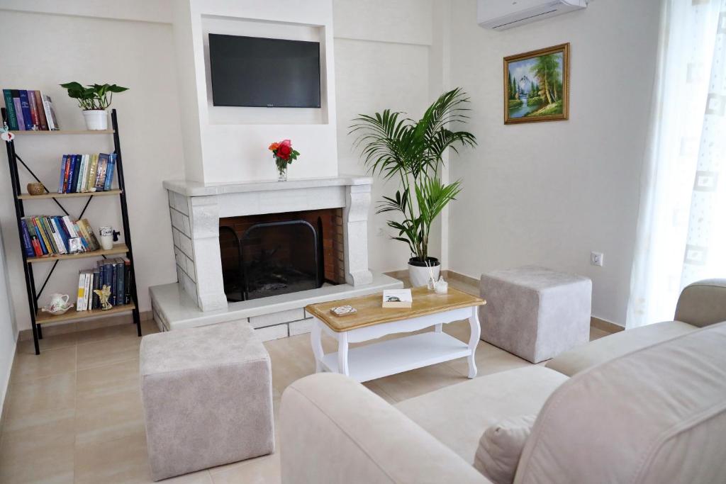 a living room with a couch and a fireplace at GK - Classic Apartment in Nafpaktos