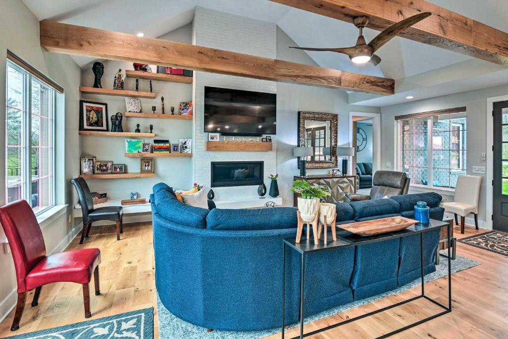 a living room with a blue couch and a table at Beautiful Nashville Home near Downtown with Hot Tub! in Nashville