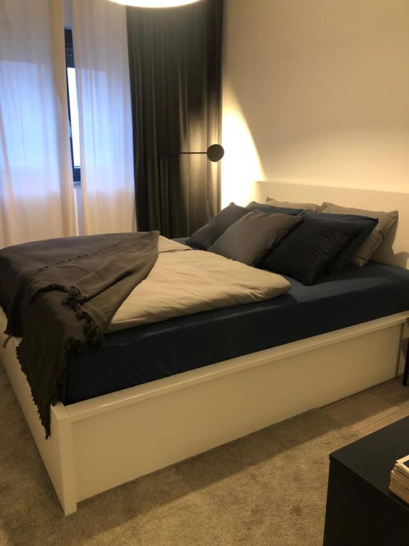 a bed in a bedroom with a black and white mattress at Bellevue in Povile