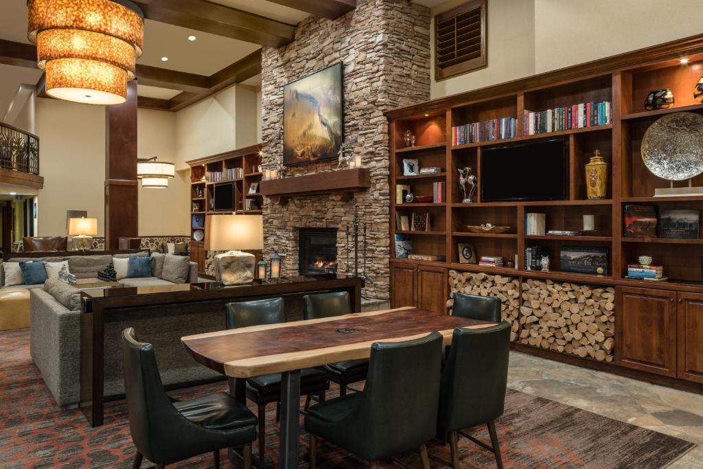a living room with a table and chairs and a couch at Sheraton Park City in Park City