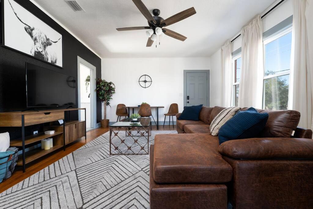 a living room with a couch and a flat screen tv at Walking distance to JAGS Stadium & Downtown in Jacksonville