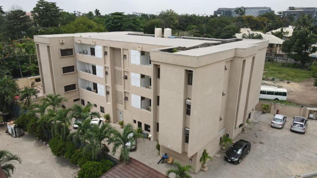 an apartment building with cars parked in front of it at Presken Residence Annex in Ikeja