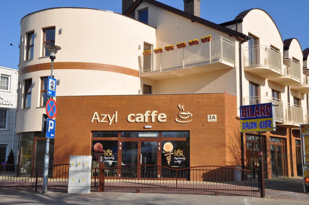 a building with aaza cafe on a city street at Azyl in Ustronie Morskie