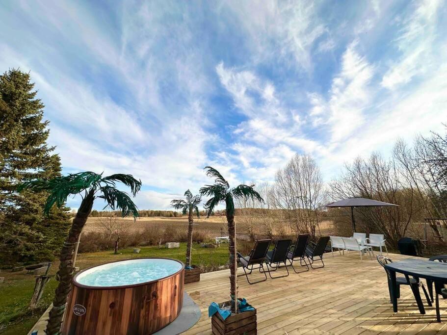 a patio with a pool and a table and chairs at Modernt & rymligt sommarhus på landet- Bubbelpool in Eskilstuna