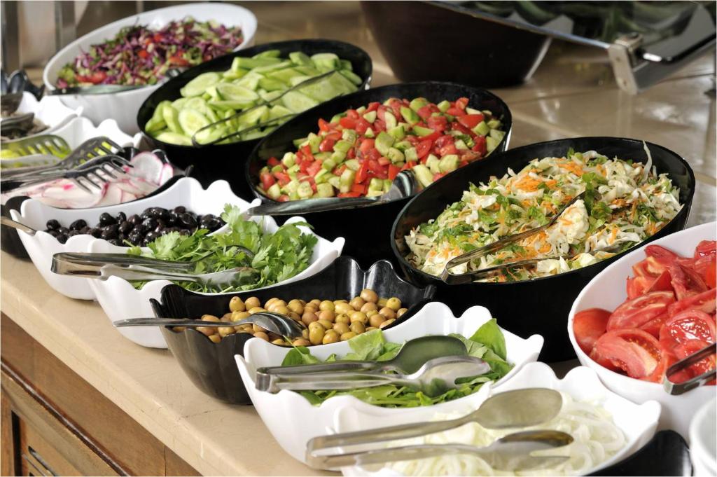 a buffet filled with different types of food in pans at Hotel Ferah in Araklı