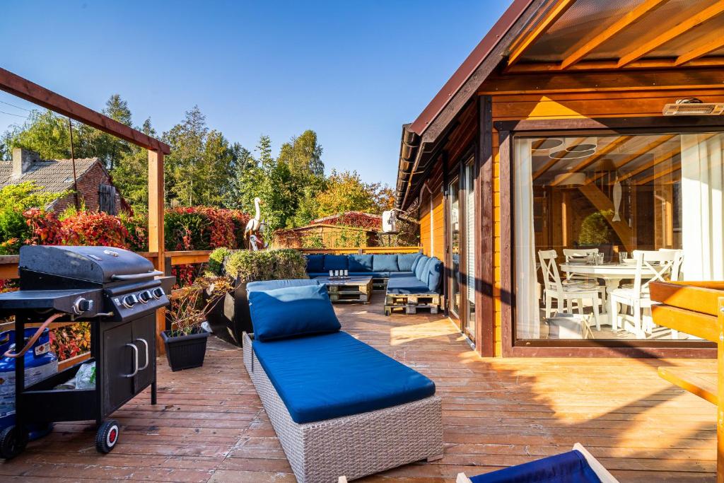 a patio with a grill and a table and chairs at Domek przy morzu in Gąski