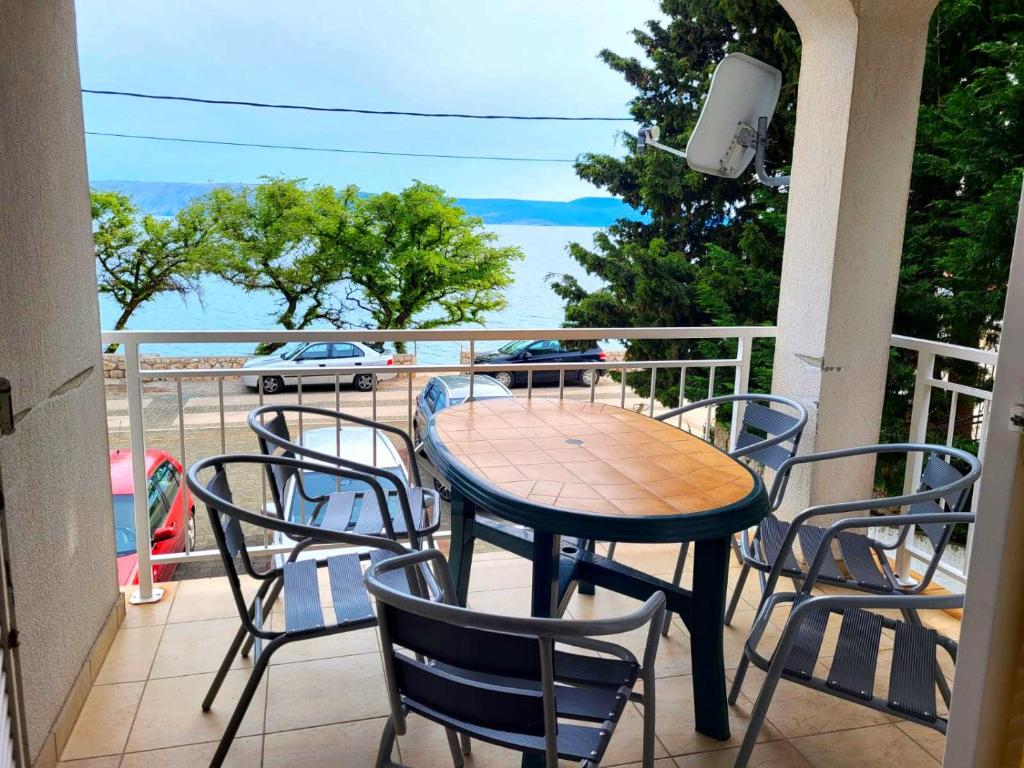 d'une table et de chaises sur un balcon avec vue sur l'océan. dans l'établissement Apartment Anna, à Novi Vinodolski