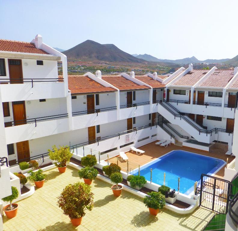 an aerial view of a building with a swimming pool at Stylish flat and pool with 3 rooms, sleeps 6, Los cristianos in Los Cristianos
