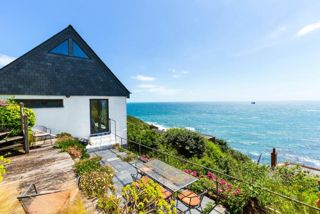a house with a view of the ocean at Dolphins in Coverack