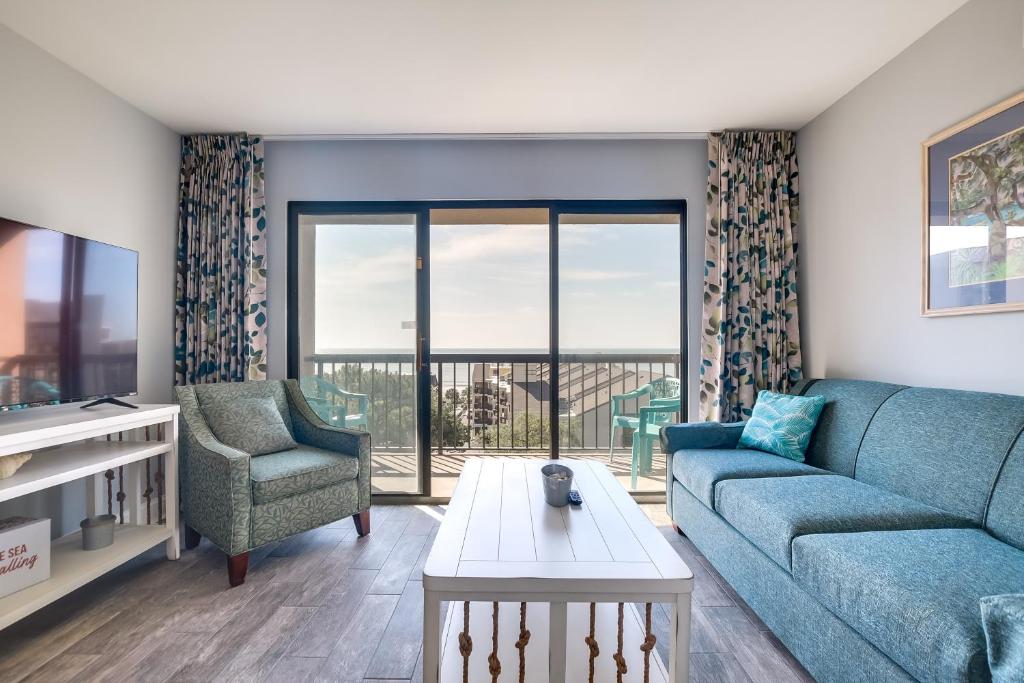 uma sala de estar com um sofá e uma mesa em Myrtle Beach Condo with Ocean View and Pool Access! em Myrtle Beach