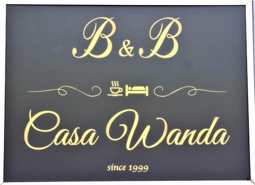 a sign for a restaurant with the words bc casa awana at B&B Casa Wanda since 1999 in Riva del Garda