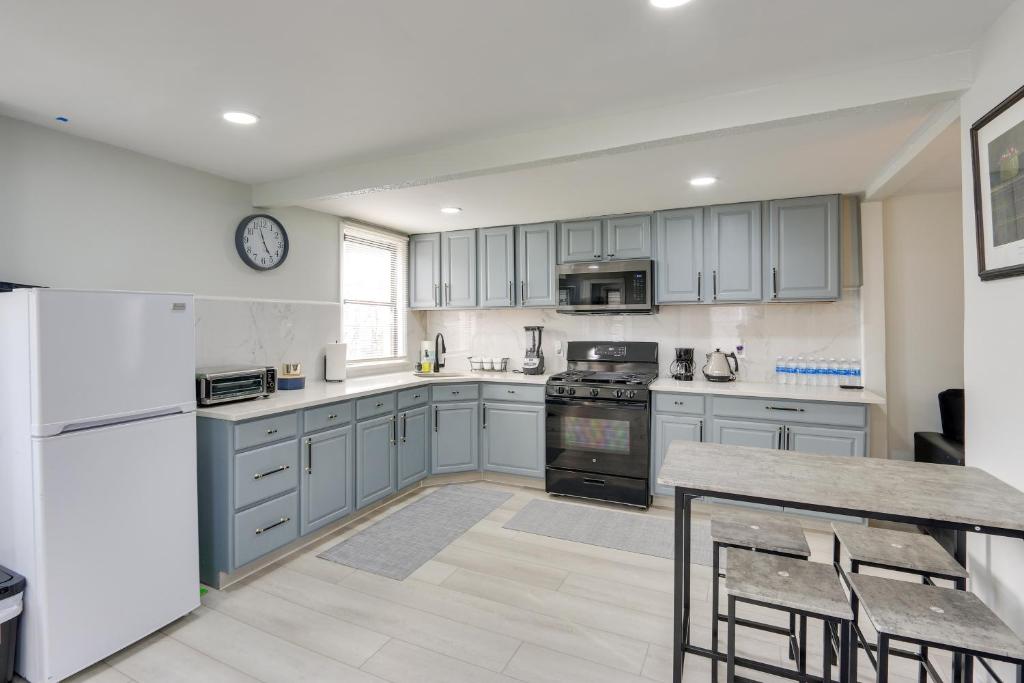 a kitchen with blue cabinets and a table with chairs at Jersey City Vacation Rental about 8 Mi to NYC! in Jersey City