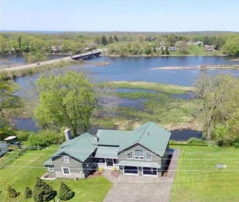 an aerial view of a house next to a river at Salmon River View in Pulaski