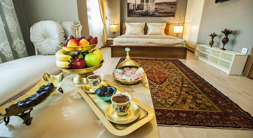 a hotel room with a tray of fruit on a bed at Million Old City Apartment in Istanbul