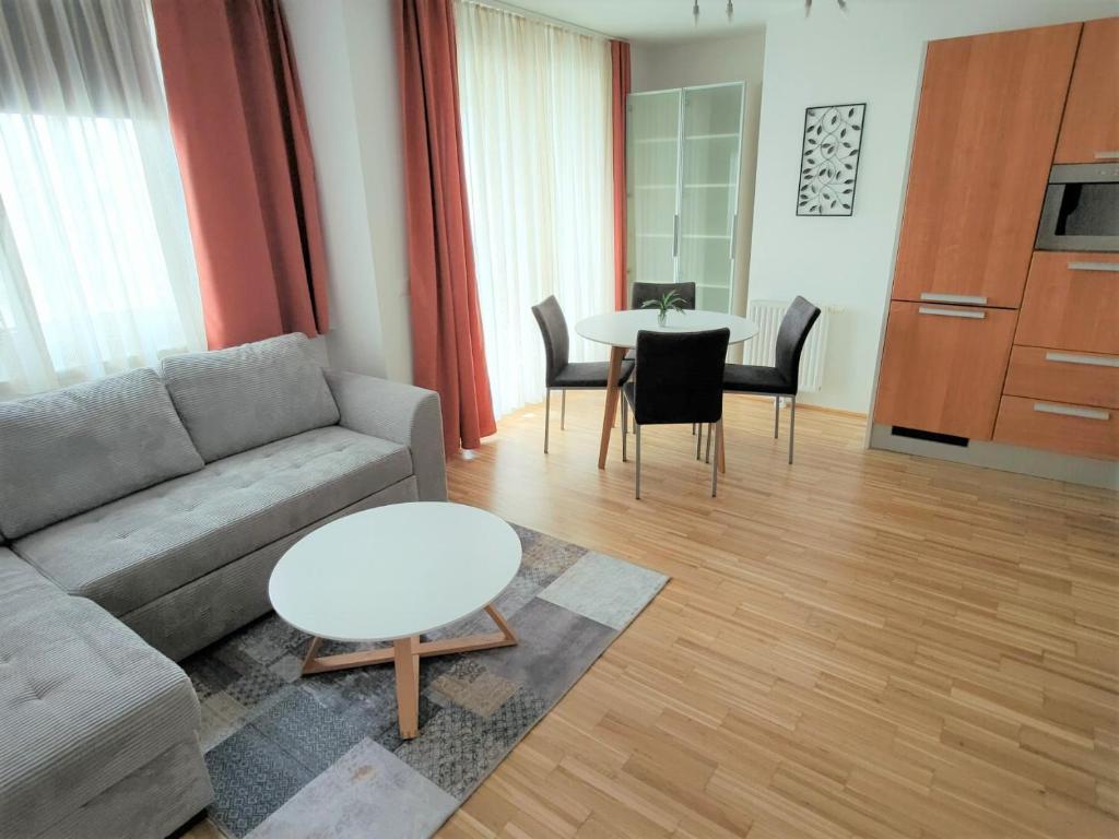 a living room with a couch and a table at Apartment Elena inklusive Garagenplatz in Vienna