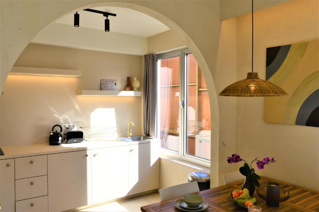 un arco en una cocina con mesa y ventana en Downtown 1BDR Apartment 4 en Amberes