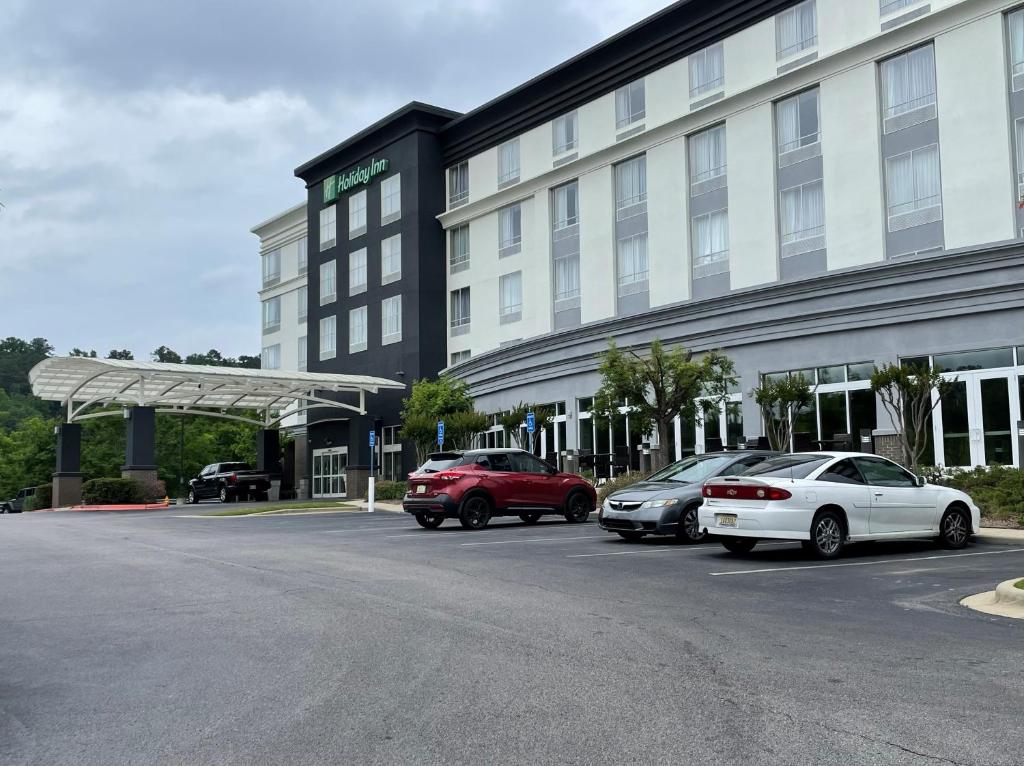 a hotel with cars parked in a parking lot at Holiday Inn Birmingham - Hoover, an IHG Hotel in Hoover