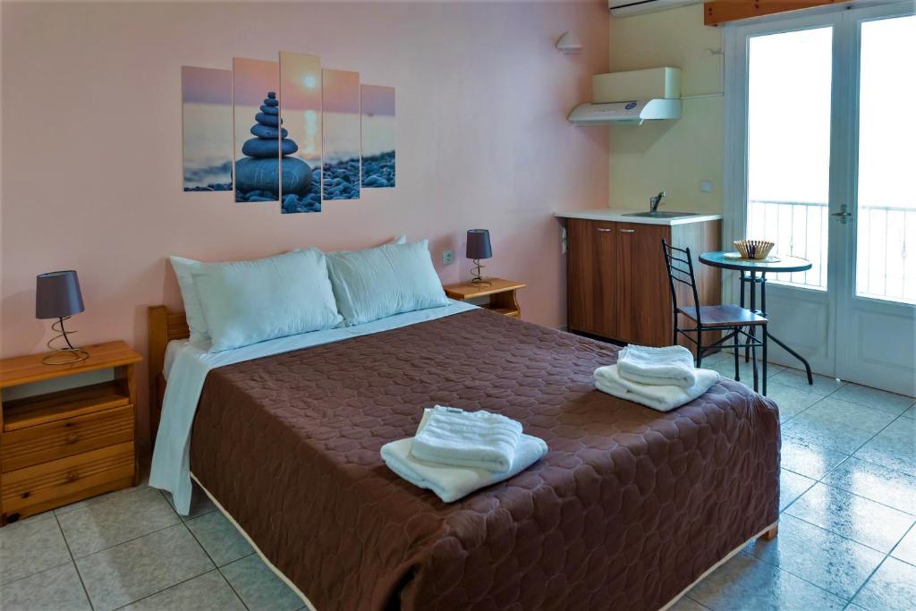 Postel nebo postele na pokoji v ubytování Zois Apartments