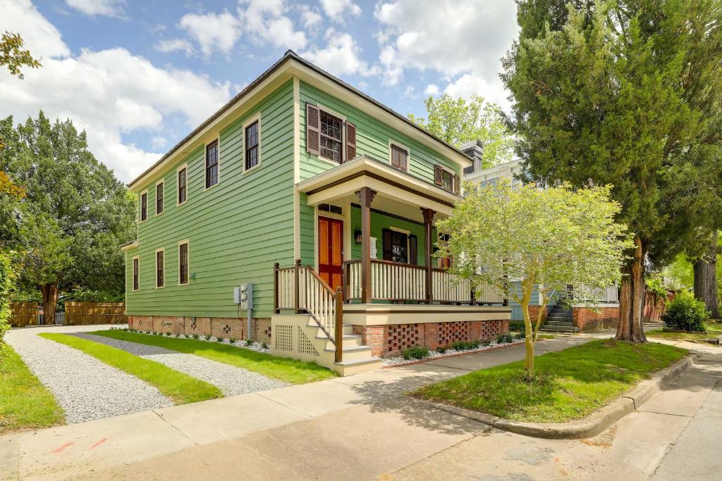 a green house with a tree in front of it at Victorian New Bern Vacation Rental In Downtown! in New Bern