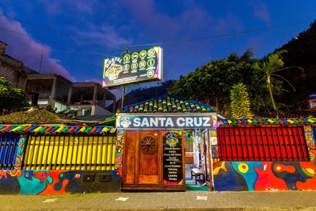 a santa cruz shop with a sign on it at Santa Cruz Backpackers Hostal in Baños