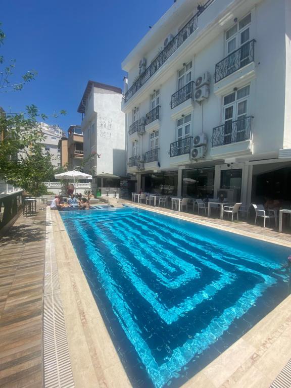 a swimming pool in front of a building at NFK The House Hotel in Antalya