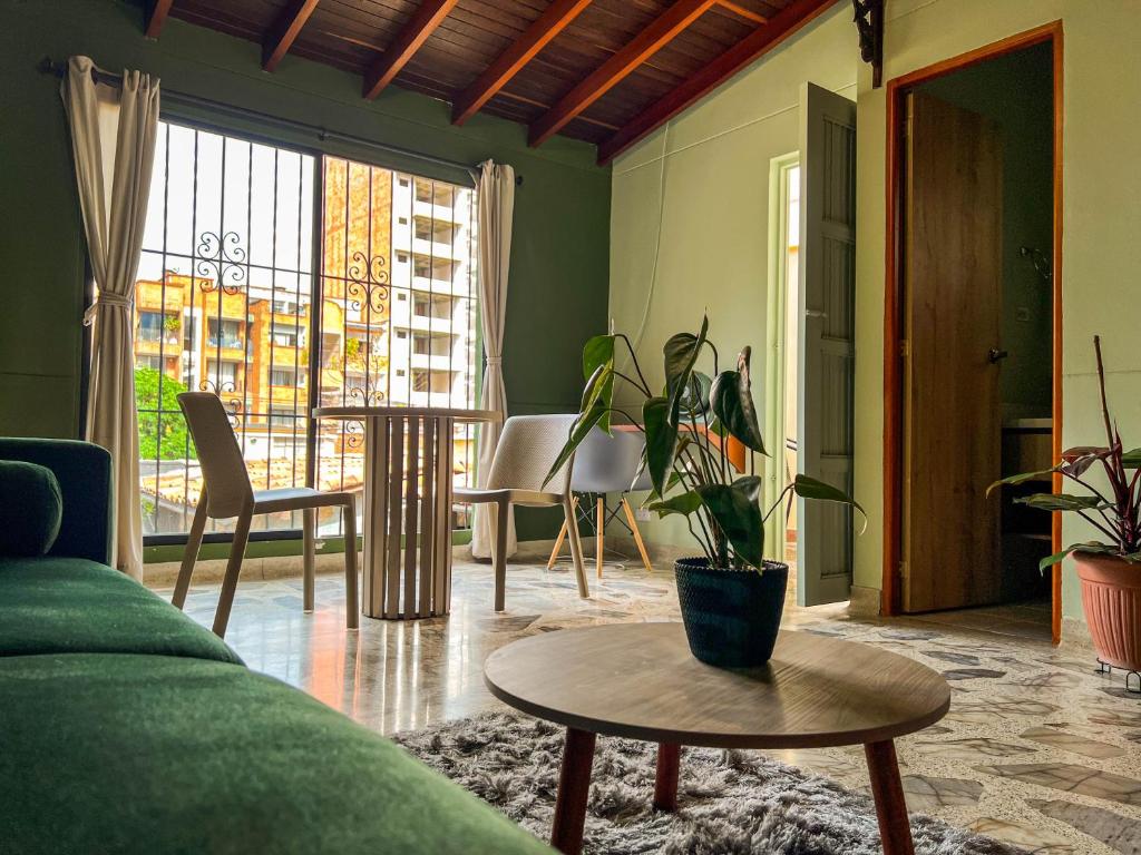 a living room with a couch and a table at Tranquil Master Suite, Your Private Escape in Medellín