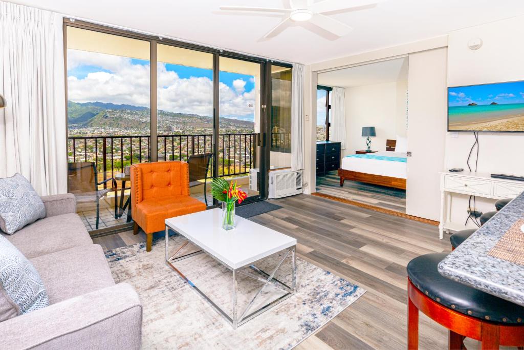 a living room with a couch and a table at Panoramic Mountain View Condo with Free Parking! in Honolulu