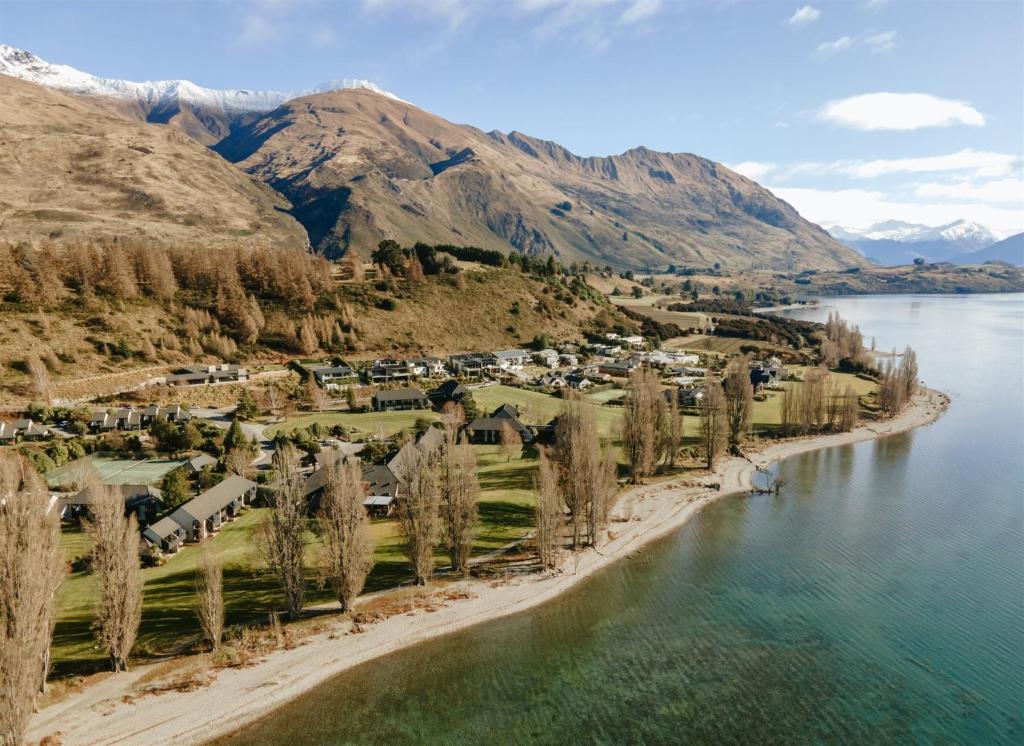 an aerial view of a village on the shore of a lake at Edgewater Hotel in Wanaka