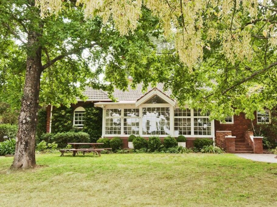 a house with a picnic table and a tree at York Cottage. A Country Retreat in Burradoo. in Burradoo