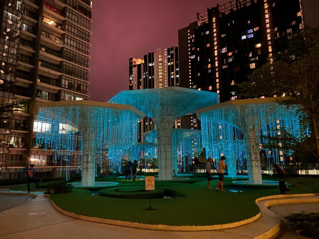 a pavilion with blue lights in a city at night at The Arte Plus KLCC BY Tenang Homes in Kuala Lumpur