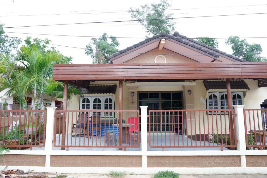 a small house with a porch and a deck at บ้านใจกลางเมืองศรีสะเกษ 3นอน2น้ำ in Si Sa Ket
