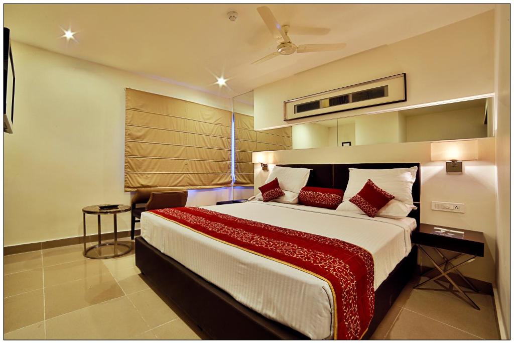 a bedroom with a large bed with a red blanket at SVN GRAND in Kākināda