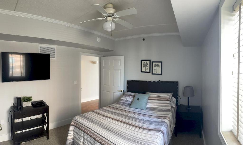 Schlafzimmer mit einem Bett und einem Deckenventilator in der Unterkunft Water Street Retreat 04 in Wilmington