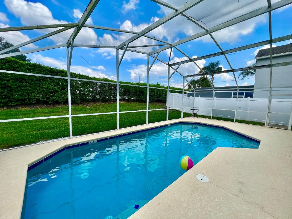 a swimming pool with a pergola over it at Grand Superior 4BR Pool House near Disney Parks in Davenport