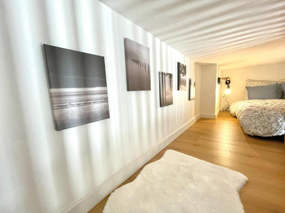 a bedroom with a bed and some pictures on the wall at Studio hypercentre in Rouen