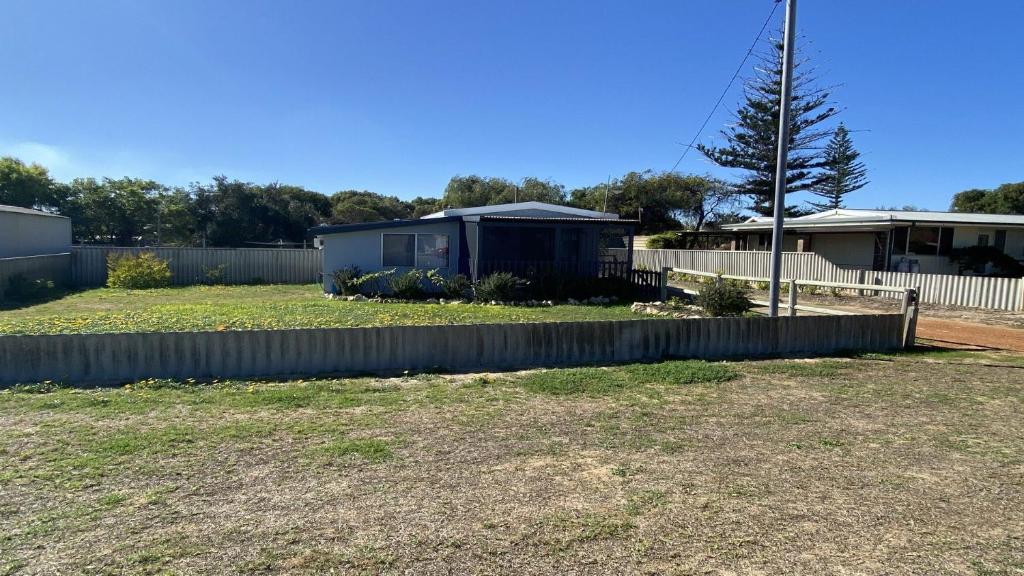 a yard with a fence and a house at Blue Marlin in Jurien Bay