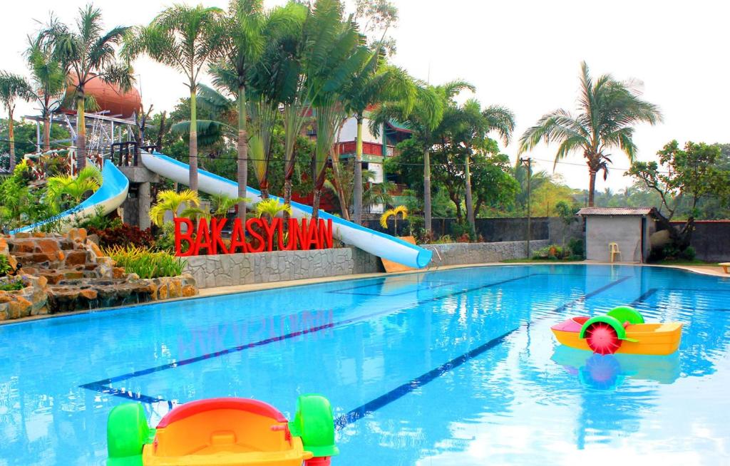 a large swimming pool with a water slide at Bakasyunan Resort and Conference Center - Zambales in Iba