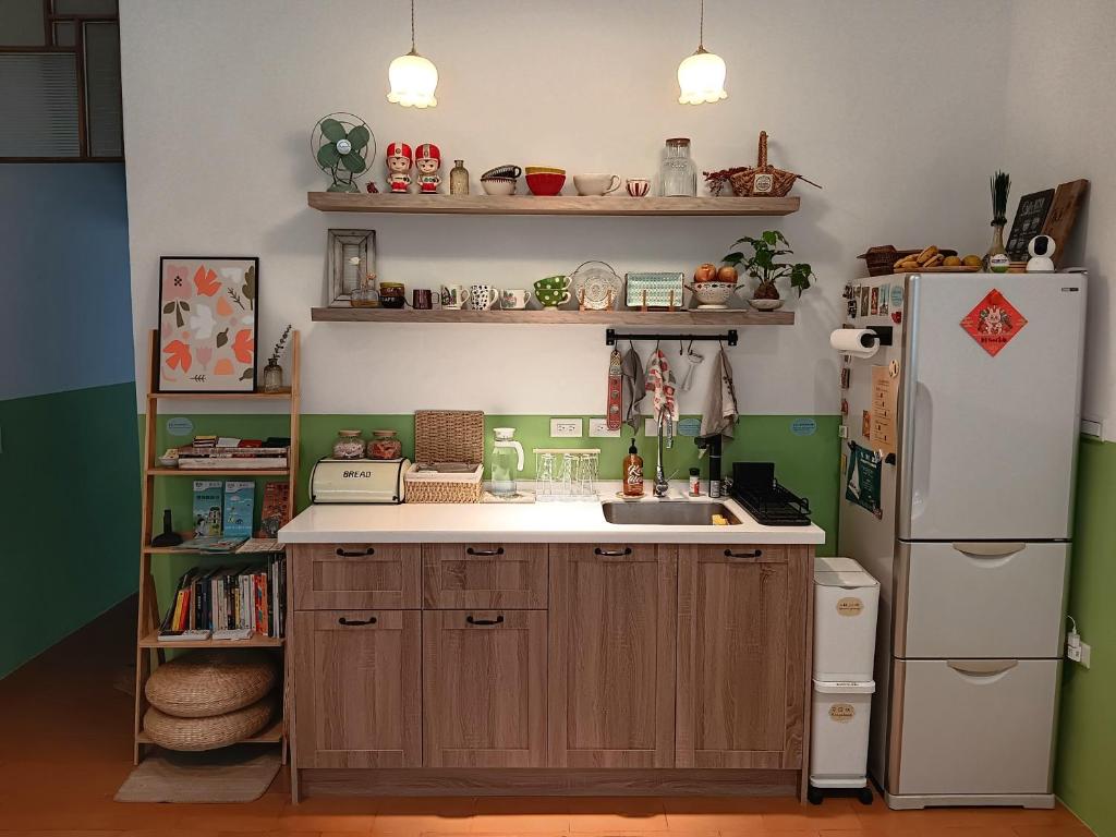 a kitchen with a white refrigerator and a sink at Good Stay in Tainan