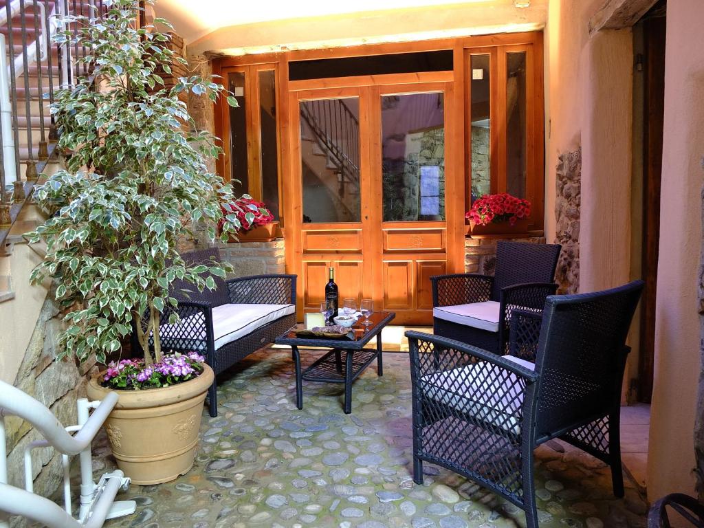 a patio with chairs and a table and a potted plant at Casa Camilla Sardegna in San Vito