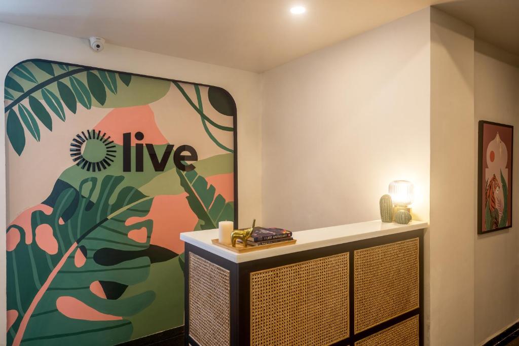 a room with a wall with a painting on the wall at Olive Hotel Electronic City by Embassy Group in Bengaluru