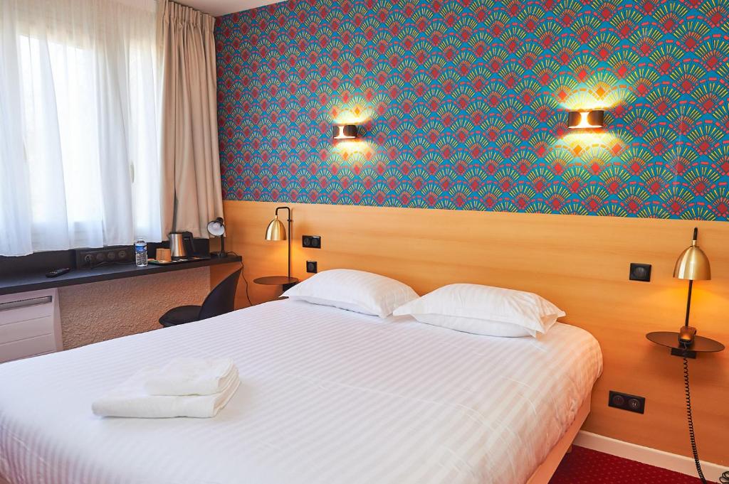 um quarto com uma cama branca e uma parede azul em Auberge du port em Bazeilles