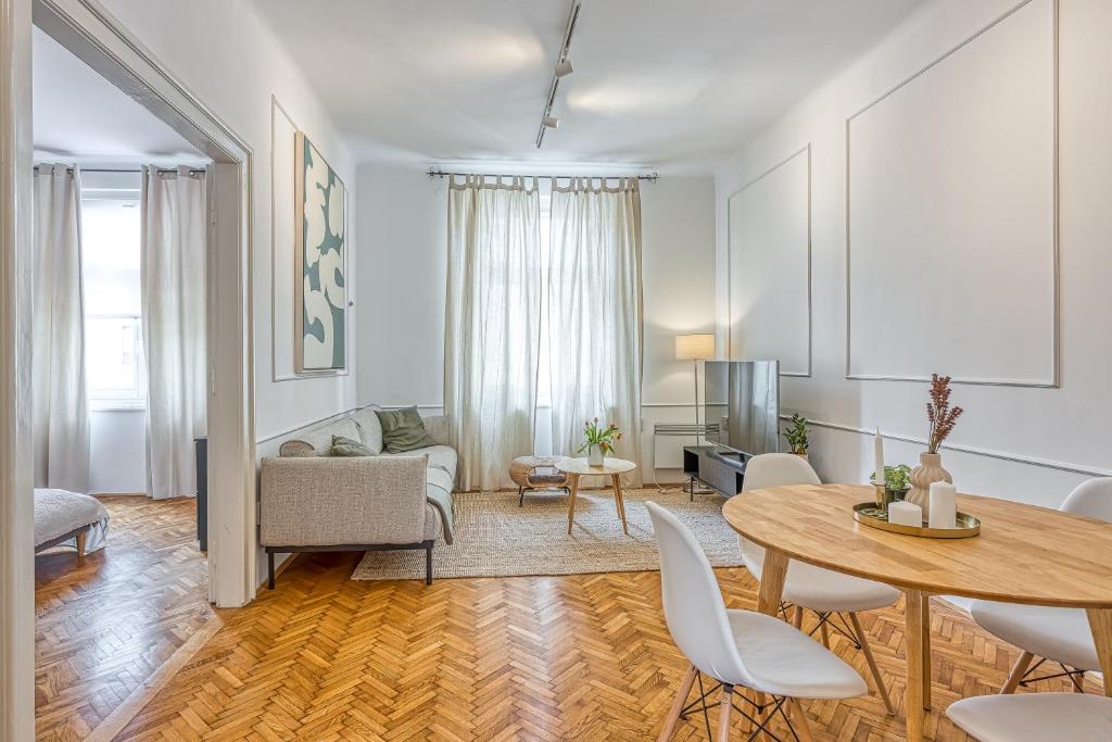 a living room with a table and a couch at Spacious Apartment In Heart Of Zagreb - Happy Rentals in Zagreb