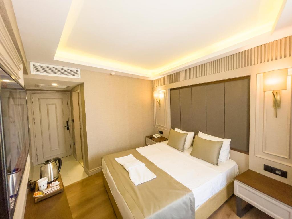 Postel nebo postele na pokoji v ubytování Martinenz Hotel