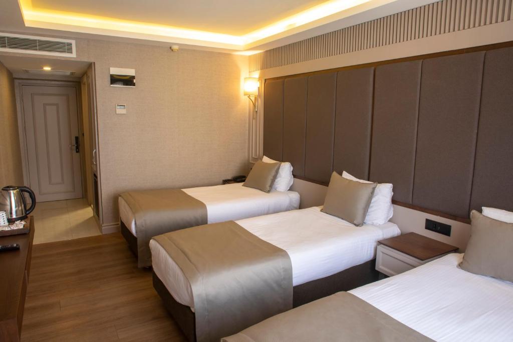 Postel nebo postele na pokoji v ubytování Martinenz Hotel